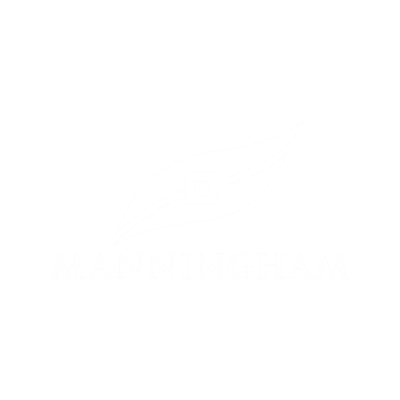 RE4ORM synthetic turf recycling – White logo featuring a stylised leaf above the word "MANNINGHAM" in capital letters, set against a transparent background.